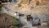 People who fled the Islamic State group's last holdout of Baghouz, in Syria's northern Deir Ezzor province, ride in the back of trucks in an area controlled by the Kurdish-led Syrian Democratic Foces (SDF) on March 4, 2019.  AFP / Bulent KILIC
