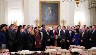 US President Donald Trump speaks behind a table of fast-food during an event in honor of the 2018 Division I FCS National Champions: The North Dakota State Bison in the State Dining Room of the White House in Washington, DC on March 4, 2019.  AFP / Mandel