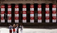 Members of the public look at the main pillars of the National Gallery of Scotland complex, that were unveiled to show an Andy Warhol 'Campbell's Soup cans' artwork covering, in Edinburgh, Scotland July 31, 2007. Reuters/David Moir