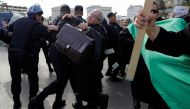 Police attempt to disperse lawyers trying to force their way to the constitutional council during a protest to denounce an offer by President Abdelaziz Bouteflika to run in elections next month but not to serve a full term if re-elected, in Algiers, Alger