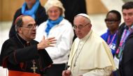 Pope Francis (R) listens to French Cardinal Philippe Barbarin (L) during an audience with homeless and socially excluded people in the Paul-VI hall at the Vatican on November 11, 2016. AFP / Alberto Pizzoli