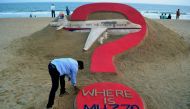 This file photo taken on March 7, 2015 shows Indian sand artist Sudarsan Pattnaik creating a sculpture of missing Malaysia Airlines flight MH370 on Puri beach in eastern Odisha state.  AFP / J K Jagdev