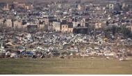 A view of people moving between tents in a makeshift camp in the last Islamic State (IS) group-controlled piece of territory in Syria's Baghouz in the eastern Deir Ezzor province.  AFP / Free Burma Rangers