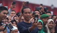 File photo of Indonesian president Joko Widodo takes a selfie as he attends the breaking the Indonesian Record Museum (MURI) in Palembang, Indonesia on March 09, 2019. A total of 500 designs Jumputan fabric with a length of 1.1 kilometers were spread out 