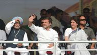Indian Congress President Rahul Gandhi (C) waves to attendees next to All India Congress Committee general secretary for eastern Uttar Pradesh Priyanka Gandhi Vadra (R) and former Indian Prime Minister Manmohan Singh during a rally at Adalaj, some 30 kms 