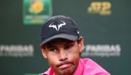 Rafael Nadal of Spain speaks to members of the media after withdrawing from his men's singles semifinal match against Roger Federer of Switzerland due to a right knee injury on Day 13 of the BNP Paribas Open at the Indian Wells Tennis Garden on March 16, 