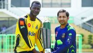 Peshawar Zalmi’s captain Daren Sammy (left) and Pakistani captain of Quetta Gladiators cricket team, Sarfraz Ahmed pose for a photograph with the Pakistan Super League Trophy at the National Cricket Stadium in Karachi, yesterday.