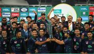 Quetta Gladiators players and officials celebrate with the   HBL Pakistan Super League trophy after defeating Peshawar Zalmi by eight wickets at the National Stadium in Karachi yesterday.