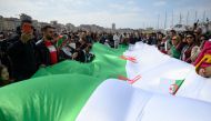 Demonstrators wave an Algerian flag during a protest over fears of plot to prolong the Algerian president's rule, on March 17, 2019, in Marseille, southeastern France. AFP / Christophe SIMON