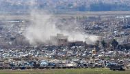 A view overlooking the camp of Baghouz where remaining Islamic State (IS) group fighters and their families are holding out in the last position controlled by IS as Syrian Democratic Forces' (SDF) fighters await to advance on them, in the countryside of t