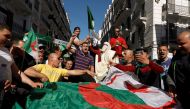 People carry their national flags as they protest over President Abdelaziz Bouteflika's decision to postpone elections and extend his fourth term in office, in Algiers, Algeria March 15, 2019. REUTERS/Zohra Bensemra
