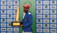 Afghanistan's Rashid Khan poses with the trophy after winning the Test cricket match between Afghanistan and Ireland at the Rajiv Gandhi International Cricket Stadium in the northern Indian city of Dehradun on March 18, 2019. AFP / Money Sharma 
