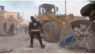 Civil defense members conduct a search and rescue operation under the rubbles of demolished buildings after airstrikes hit the residential areas of de-escalation zone Idlib, Syria on March 22, 2019. ( Hasan Muhtar - Anadolu 