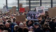 People hold placards during a demonstration under the slogan 
