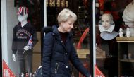A woman walks past a tourist shop in the centre of Stratford-upon-Avon, Britain, March 22, 2019. REUTERS/Peter Nicholls