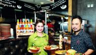 Nandos staff in new uniform with dishes introduced in the new menu. Pic: Qassim Rahmatullah / The Peninsula