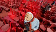 A supporter of India's ruling Bharatiya Janata Party (BJP) wearing a mask of Narendra Modi checks his mobile phone as he attends an election campaign rally being addressed by Modi in Meerut in the northern Indian state of Uttar Pradesh, India, March 28, 2