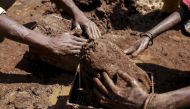 Labourers shape mud bricks as they work at a kiln in India, March 10, 2016. Reuters/Danish Siddiqui