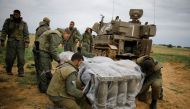Israeli soldiers cover shells next to a mobile cannon near the border with Gaza, in southern Israel March 29, 2019. Reuters/Amir Cohen