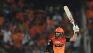 Sunrisers Hyderabad cricketer David Warner raisse his bat after scoring fifty (50) runs during the 2019 Indian Premier League (IPL) Twenty20 cricket match between Sunrisers Hyderabad and Rajasthan Royals at The Rajiv Gandhi International Cricket Stadium i
