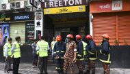 Bangladeshi forensic experts work at the scene of the burnt building along with firefighters in Dhaka on March 29, 2019, a day after flames tore through the 22-storey FR Tower. AFP/Munir Uz Zaman 