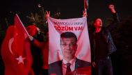 Supporters of the main opposition Republican People's Party (CHP) unfurl a portrait of candidate Ekrem Imamoglu to celebrate local election in Istanbul, Turkey on 1 April 2019. AFP / Yasin AKGUL