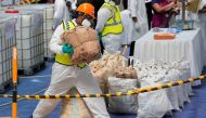 A Sri Lankan police narcotic bureau officer places a haul of seized cocaine sacks to be destroyed under judicial supervision in Colombo, Sri Lanka April 1, 2019. REUTERS/Dinuka Liyanawatte