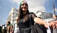 Algerian students raise banners and placards as they take part in a demonstraion against the current government in the capital Algiers on April 2, 2019.  AFP / RYAD KRAMDI