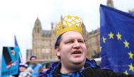 A pro-EU demonstrator wears headgear featuring the EU outside the Houses of Parliament in central London on April 2, 2019. AFP / ISABEL INFANTES