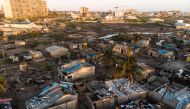 Debris and destroyed buildings which stood in the path of Cyclone Idai can be seen in this aerial photograph over the Praia Nova neighbourhood in Beira on April 1, 2019.   AFP / Guillem Sartorio
