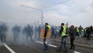 Protesters stand in front of French gendarmes during a 