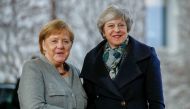 FILE PHOTO: German Chancellor Angela Merkel (R) greets British Prime Minister Theresa May at the Chancellery in Berlin. AFP / Odd ANDERSEN
