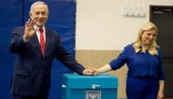 Israeli Prime Minister Benjamin Netanyahu (L) and wife Sara cast their ballot during Israel's parliamentary elections in Jerusalem, on April 9, 2019. AFP/Ariel Schalit 
