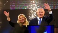 Israeli Prime Minister Benjamin Netanyahu and his wife Sara wave as Netanyahu speaks following the announcement of exit polls in Israel's parliamentary election at the party headquarters in Tel Aviv, Israel April 10, 2019. REUTERS/Ammar Awad