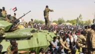 Sudanese soldeirs stand guard around armoured military vehicles as demonstrators continue their protest against the regime near the army headquarters in the Sudanese capital Khartoum on April 11, 2019.   AFP / -
