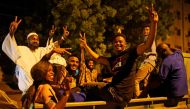 Sudanese demonstrators celebrate after the Defence Minister Awad Ibn Auf stepped down as head of the country's transitional ruling military council, as protesters demanded quicker political change, outside the Defence Ministry in Khartoum, Sudan April 13,