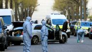 Police forensics officers work at the site where police fired shots after a vehicle rammed the parked car of Ukraine's ambassador, outside the Ukrainian embassy in London, Britain, April 13, 2019. REUTERS/Gonzalo Fuentes