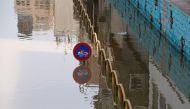 This picture taken on April 11, 2019 shows a street sign partially submerged by water from floods in Ahvaz, the capital of Iran's southwestern province of Khuzestan Authorities ordered tens of thousands of residents of the southwestern Iranian city of Ahv