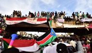 Sudanese demonstrators gather near the military headquarters in the capital Khartoum on April 14, 2019. / AFP / Ahmed MUSTAFA