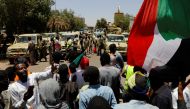Sudanese demonstrators chant slogans in front of security forces during a protest in Khartoum, Sudan April 15, 2019. REUTERS/Umit Bektas