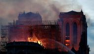 Fire fighters douse flames of the burning Notre Dame Cathedral in Paris, France April 15, 2019. REUTERS/Benoit Tessier