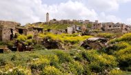 A view of damaged buildings and Aleppo's ancient citadel in the background, in the old city, Syria April 9, 2019. Picture taken April 9, 2019. REUTERS/Omar Sanadiki
