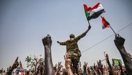 Sudanese protestors shout slogans as they carry a Sudanese officer during a protest outside the army complex in the capital Khartoum on April 18, 2019.  AFP / Ozan Kose