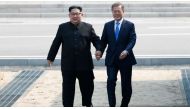 File photo of North Korea's Kim Jong-un, South Korea's Moon Jae-in plant tree for peace at border , Reuters