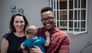 (L to R) Cheryl (31), Camden (6 months) and Mpho Mojapelo (35) pose in their home in Johannesburg on March 7, 2019.  AFP / Gulshan Khan
 
