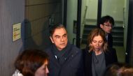 FILE PHOTO: Former Nissan Chairman Carlos Ghosn (2nd L) and his wife Carole (2nd R) leave the office of his lawyer in Tokyo.   AFP / Kazuhiro NOGI 