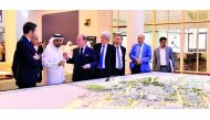 QU President Dr Hassan Al Derham shows Thales officials a model of the university.