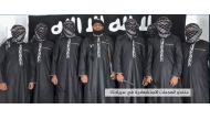 An image grab taken from a press release issued on April 23, 2019 by the Islamic State (IS) group's propaganda agency Amaq, allegedly shows eight men it said carried out a string of deadly suicide bomb blasts on Easter Sunday in Sri Lanka, lined up at an 