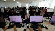 Volunteers use computer as they input data of vote tally forms, of this month's election, in a room at Joko Widodo's national campaign team office in Jakarta, Indonesia, April 29, 2019. Picture taken April 29, 2019. REUTERS/Willy Kurniawan