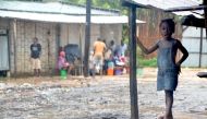 A little girl stands on the porch of her house in the Paquite district of Pemba on April 29, 2019, as Cyclone Kenneth hit northern Mozambique, killing 38 and destroying thousands of home.  AFP / EMIDIO JOZINE
